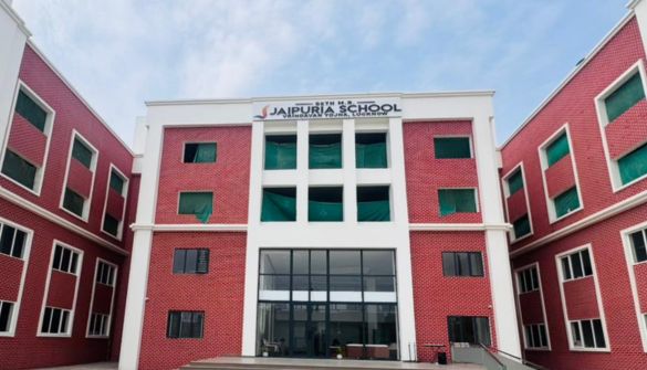 Seth MR Jaipuria School Vrindavan Yojna Lucknow - Jaipuria Schools - Jaipuria Schools Front view of Jaipuriya School building, red brick with white trim and a glass central entrance, signage at the top.